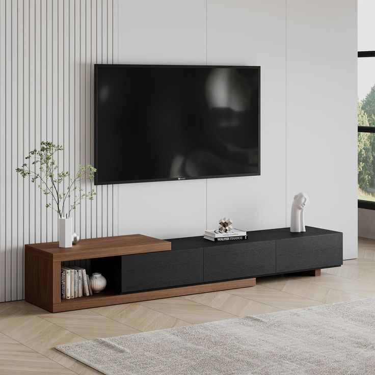 a living room with a large flat screen tv mounted on the wall and a wooden entertainment center