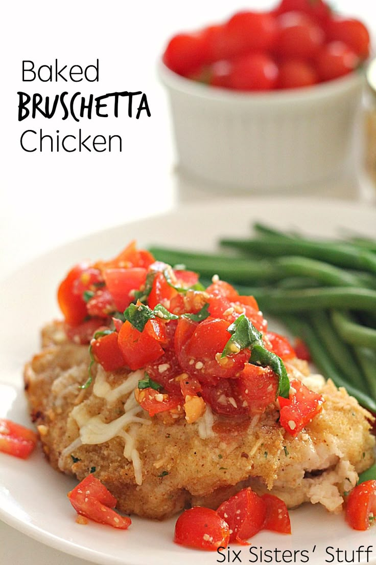 chicken with tomatoes and green beans on a white plate