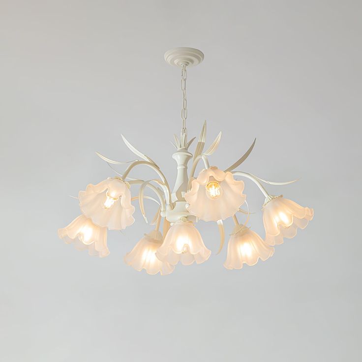 a white chandelier with flowers hanging from it's center and four lights on each side