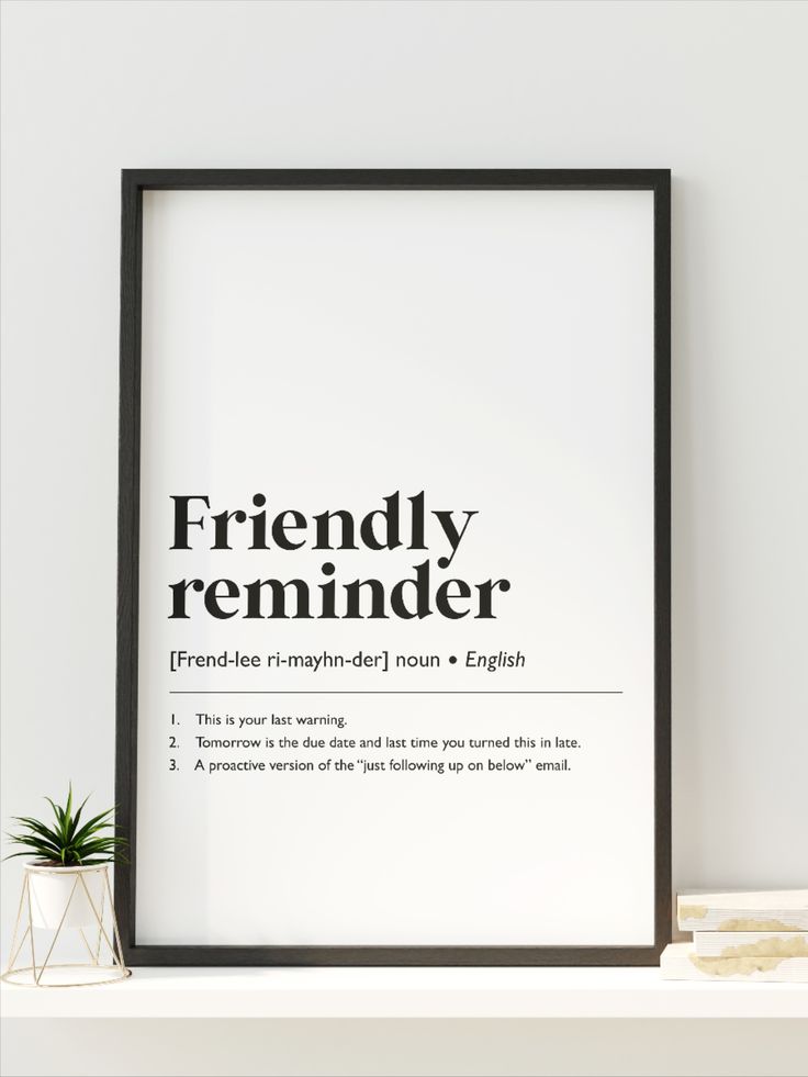 a black and white poster with the words friendly reminder on it next to a potted plant