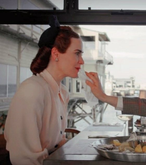 two women sitting at a table with food in front of them