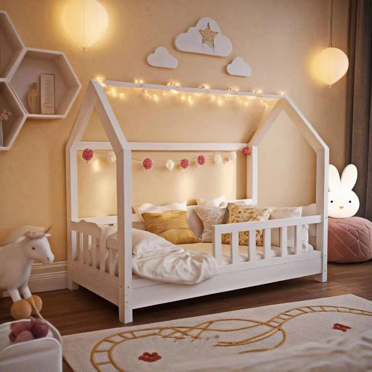 a child's bedroom with a white bed and lights