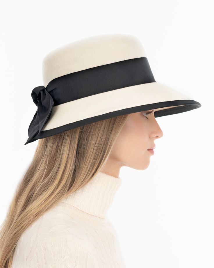 A women’s fall felt hat, trimmed with grosgrain that is timeless and chic. This is a special occasion style, not to be worn casually, which adds grace and presence. Viewed from the front, the dressy silhouette reminds one of Audrey Hepburn’s hats; a medium size brim curves gently downward .The unexpected surprise feature is the cutaway tulip shape of the brim in back, which finishes in a feminine double bow. UPF 50+ Blocks 98% UVA/UVB rays Hand blocked Elasticized inner band for comfortable fit Winter Bags, Elegant Hats, Double Bow, Straw Bags, Leather Hats, The Unexpected, Felt Hat, Wide Brimmed Hats, Brim Hat