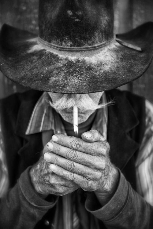 an old man wearing a cowboy hat and holding his hands to his face with the words if