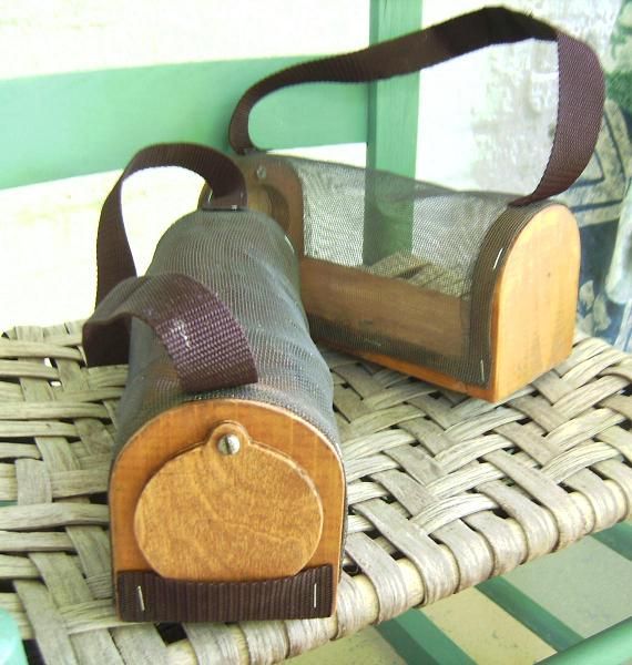 a bag sitting on top of a wicker chair next to another bag in front of a window