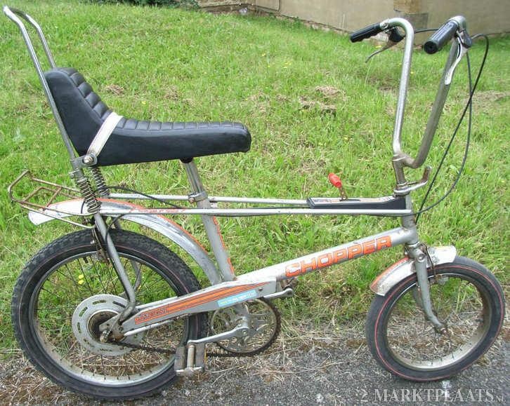 an old bicycle is parked in the grass