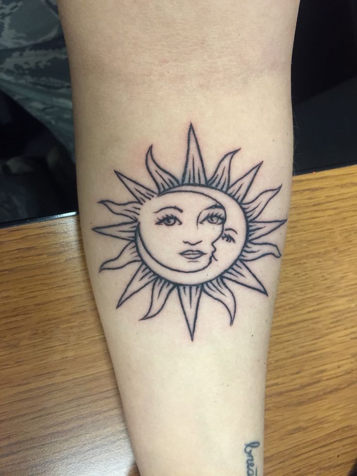 a sun and moon tattoo on the leg