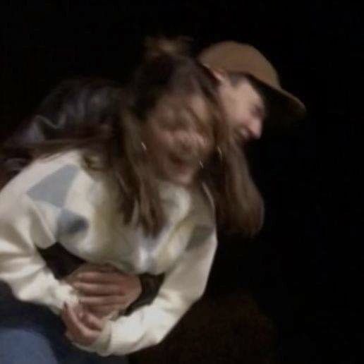 two people are dancing together in the dark