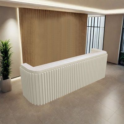 an empty room with a large white radiator next to a potted plant