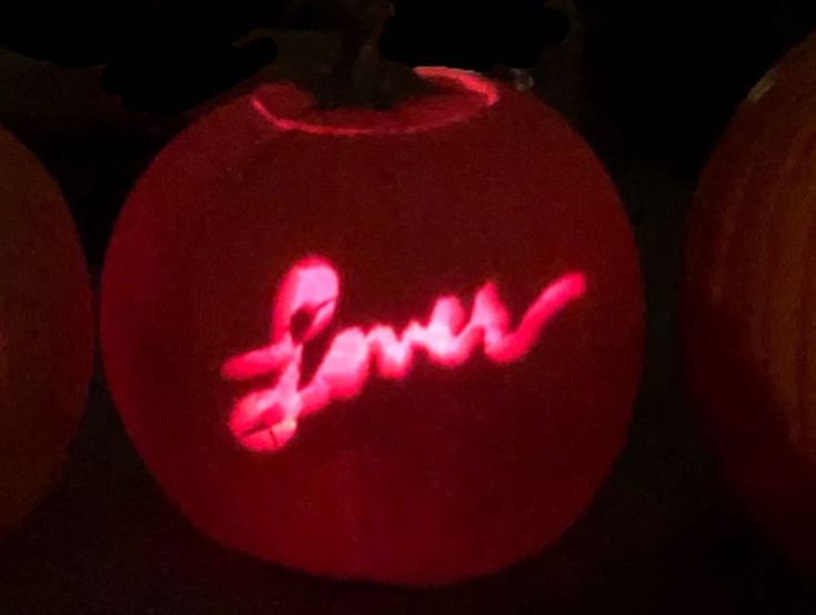 three carved pumpkins with the word boo written on them