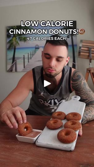 a man sitting at a table with doughnuts in front of him and the caption low calorie cinnamon donuts 47 calories each