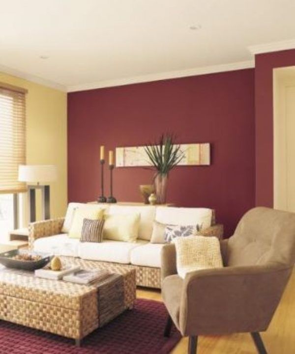 a living room with red walls and white furniture