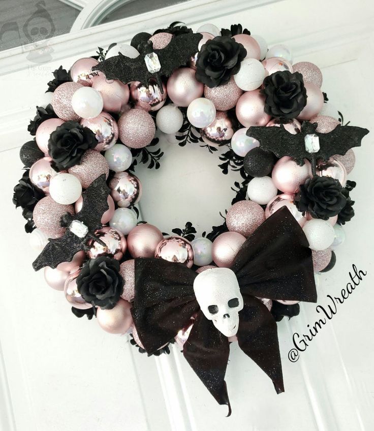 a wreath decorated with black and pink ornaments