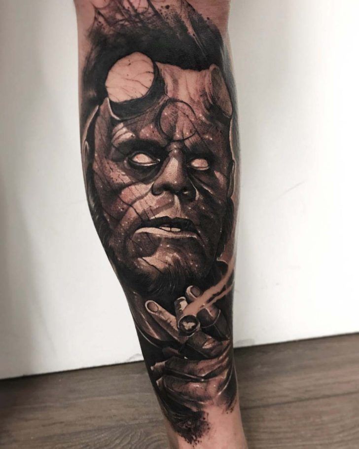 a man's leg with a tattoo on it that has a face and knife in it