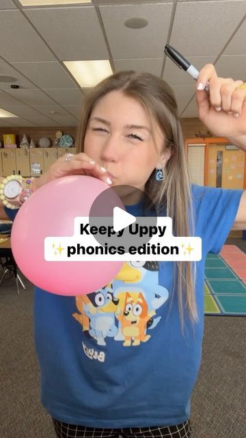 a girl is holding a balloon in her hand and the caption reads, keep uppy phonics edition