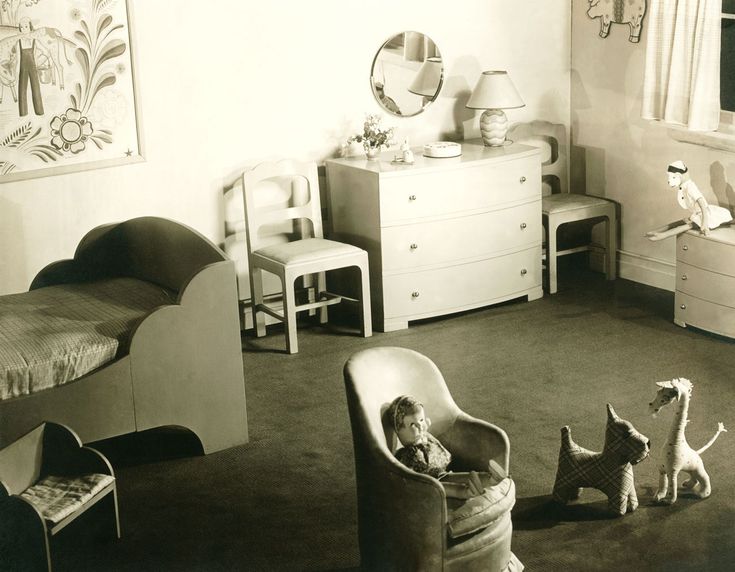 an old black and white photo of a child's bedroom