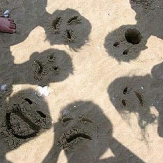 an image of someone's shadow in the sand with their hands and footprints on it