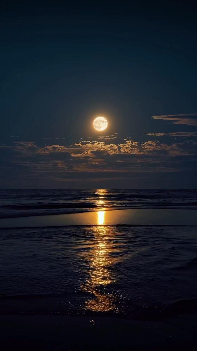 the moon is shining brightly over the ocean