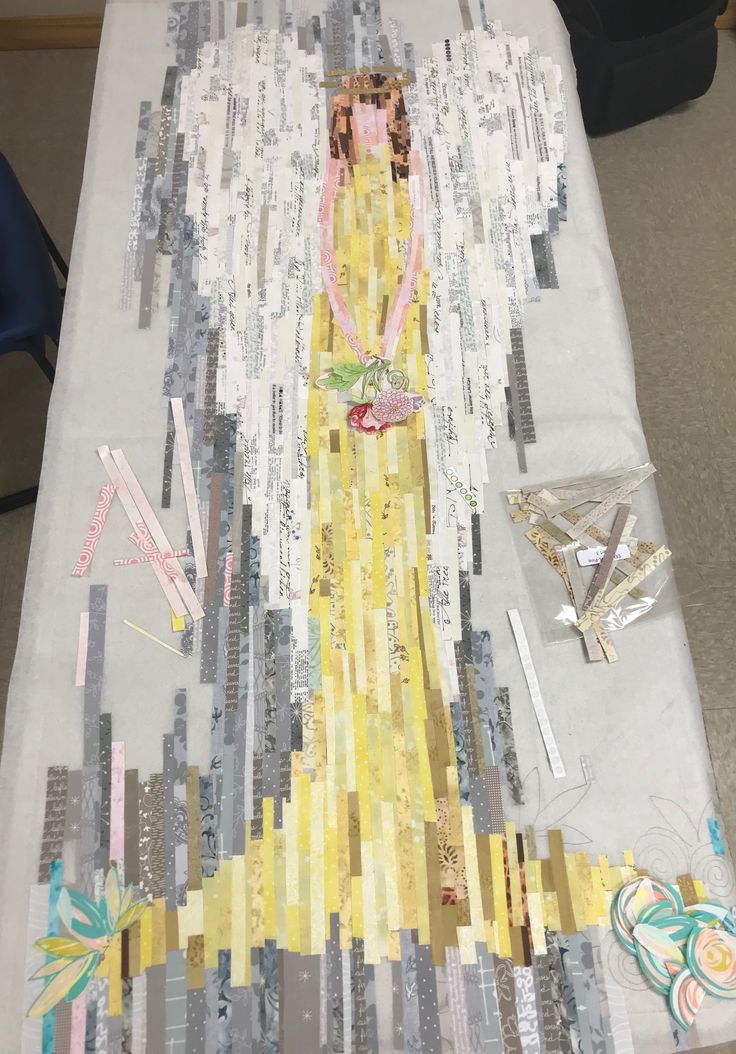 a table topped with lots of different types of paper and scissors on top of it