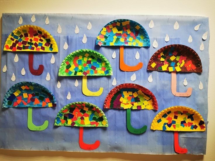 paper plate umbrellas are displayed on a wall