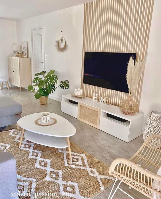 a living room filled with furniture and a flat screen tv on top of a wall