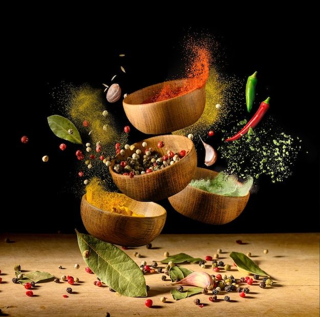 three wooden bowls filled with spices on top of a table