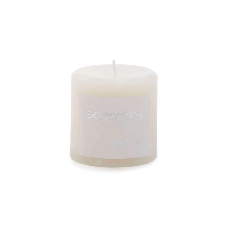 a white candle with the word serenity on it