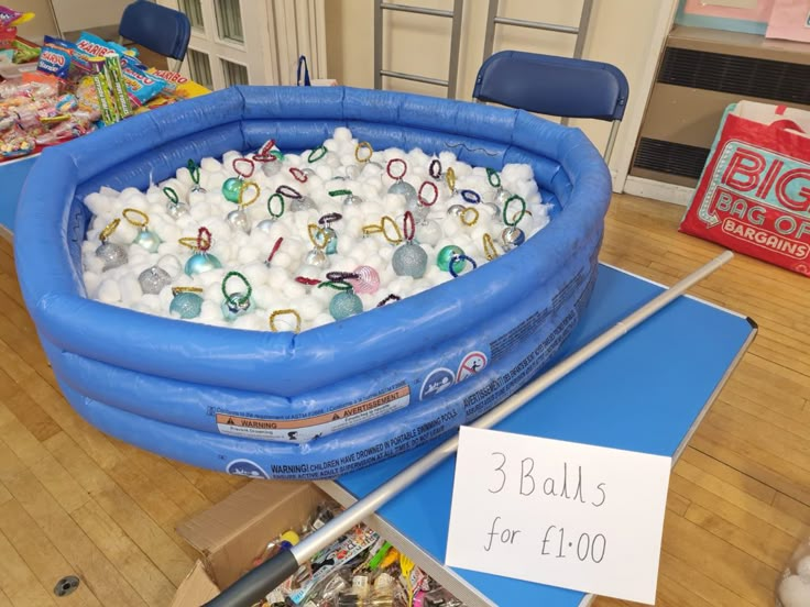 an inflatable pool filled with balls and rings for $ 1, 500 is on display