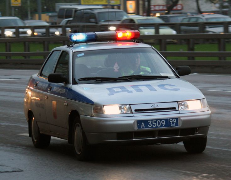 a police car driving down the road with its lights on