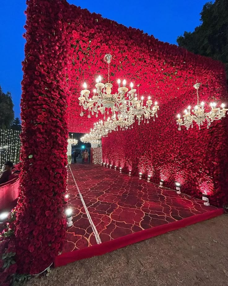 a red carpet covered in flowers and chandeliers