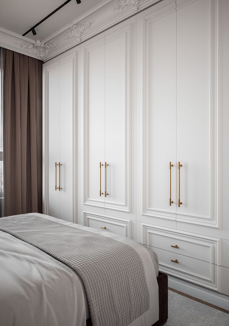 a bedroom with white walls and closets