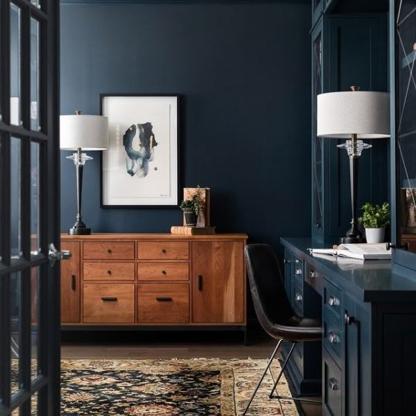 a living room with blue walls and furniture