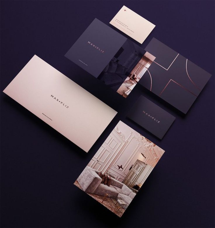 an assortment of brochures and business cards on a black surface with gold accents