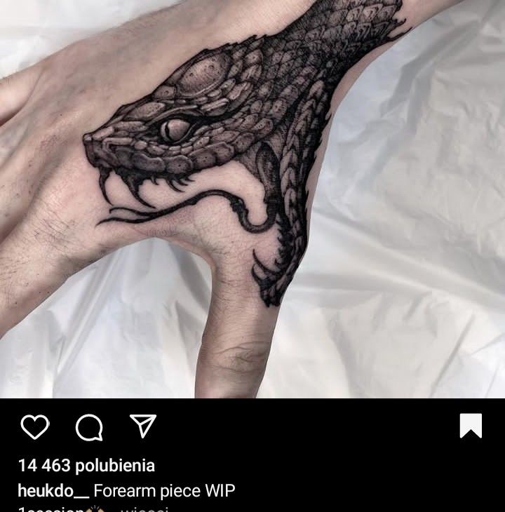 a person's hand with a tattoo on it