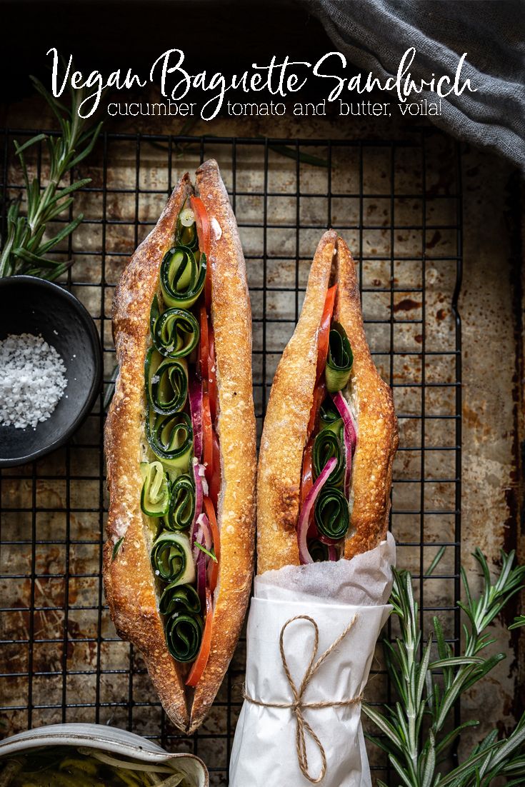 two baguette sandwiches with veggies, tomato and butter