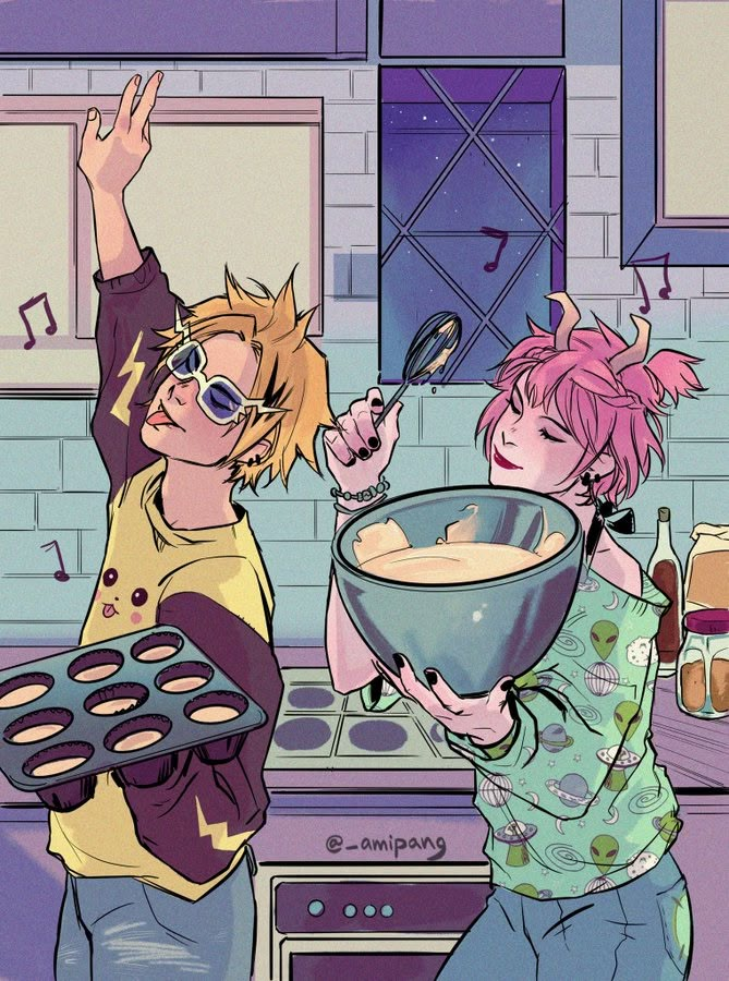 two people in the kitchen with some muffins on their hands and one holding a bowl