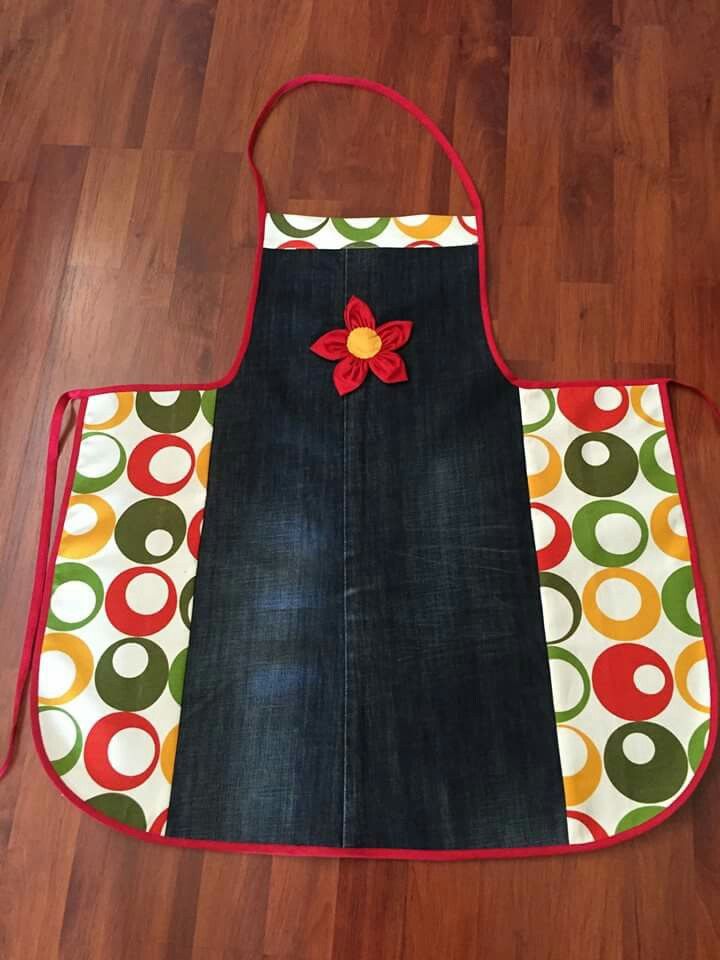 an apron with the words emiisin hollier on it sitting on a wooden floor