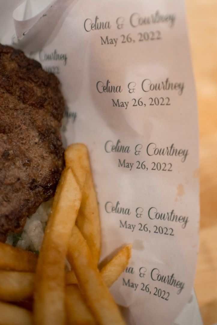 a hamburger and french fries sitting on top of a piece of paper