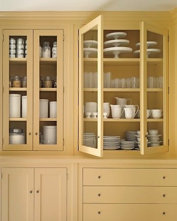 an empty china cabinet with dishes in it