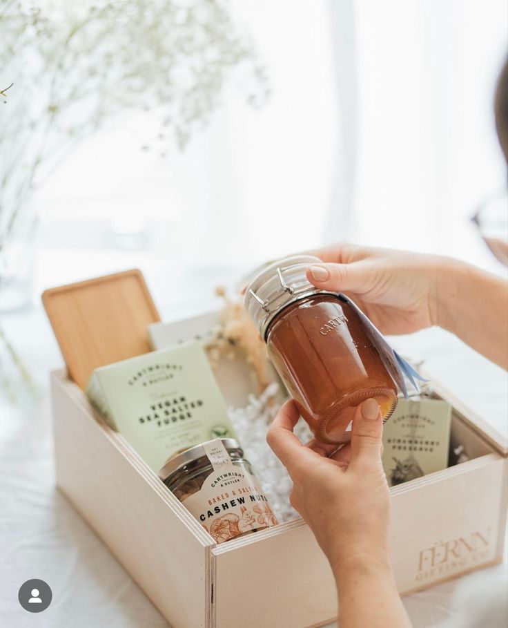 a woman is holding a jar of honey in her hand