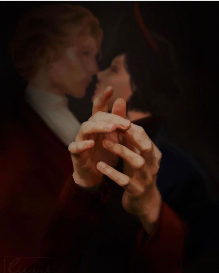 a man and woman are kissing in front of a dark background with their hands touching each other