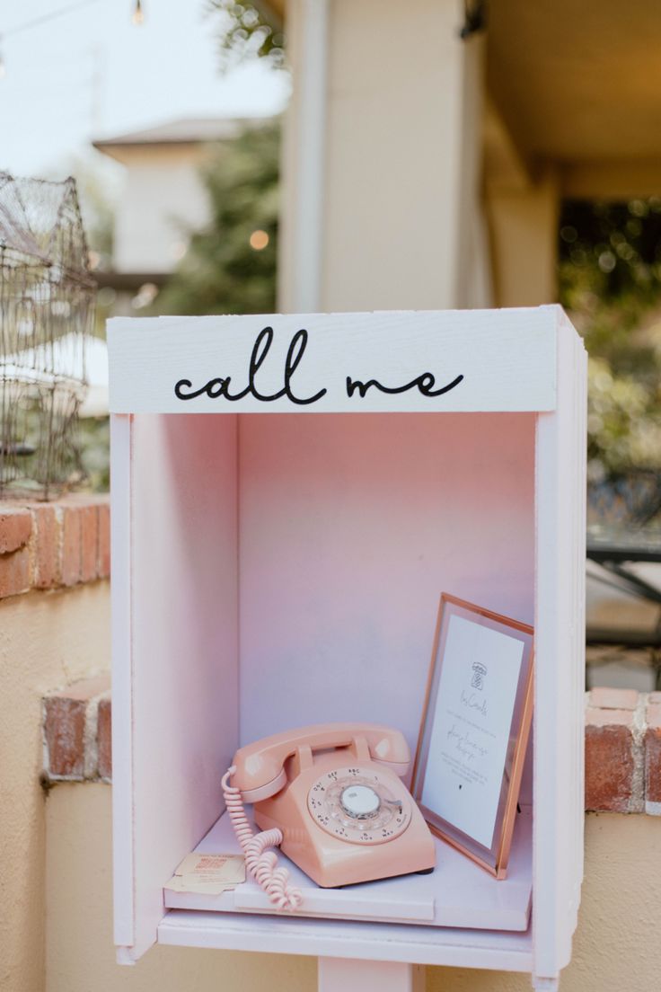 an old fashioned phone is on display in a box with the word call me written on it