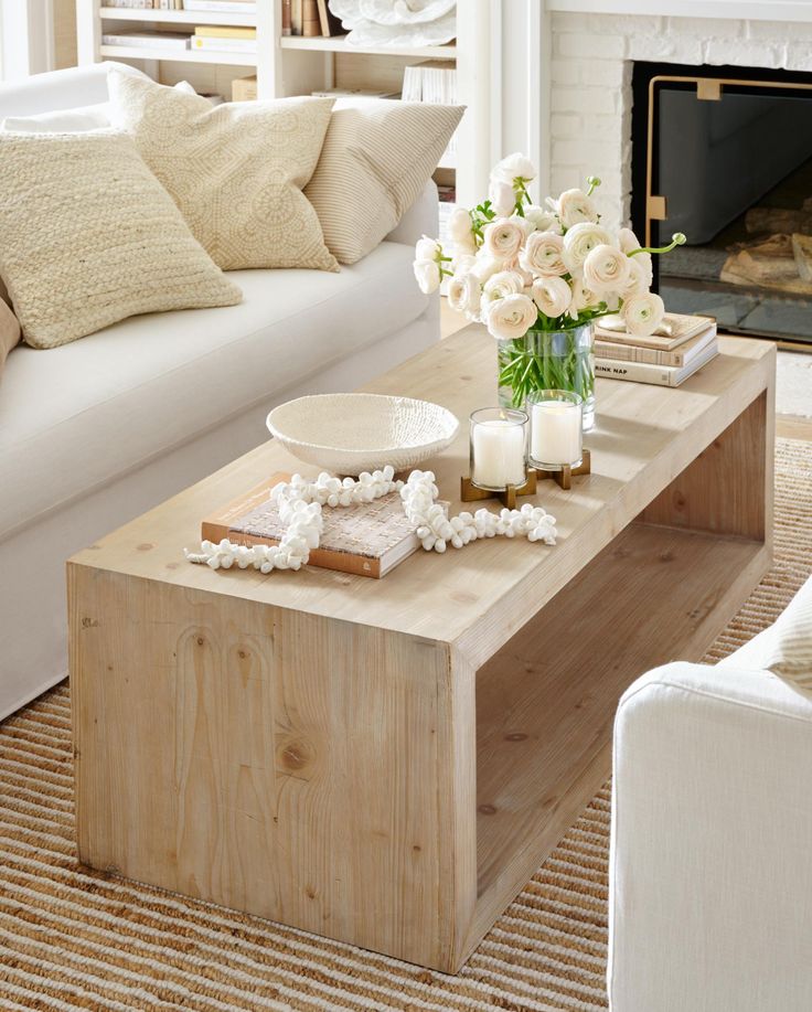 a living room filled with furniture and a fire place in front of a white couch