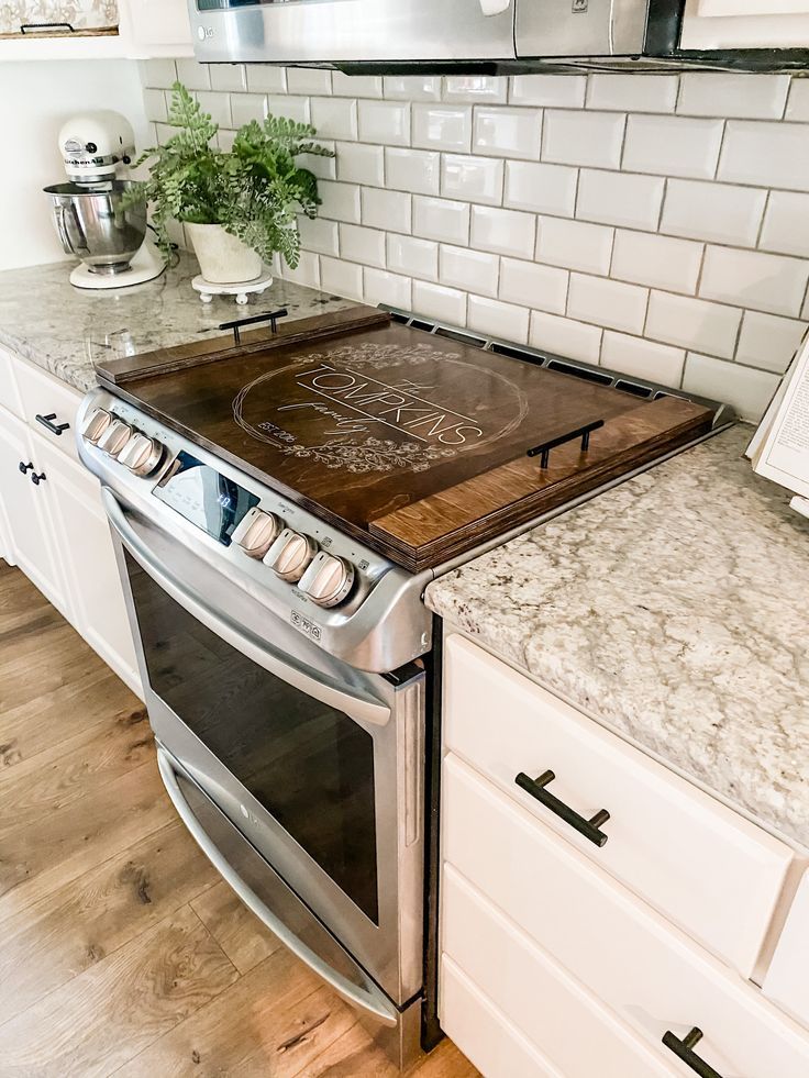 a kitchen with an oven, stove and counter top that has the word love written on it