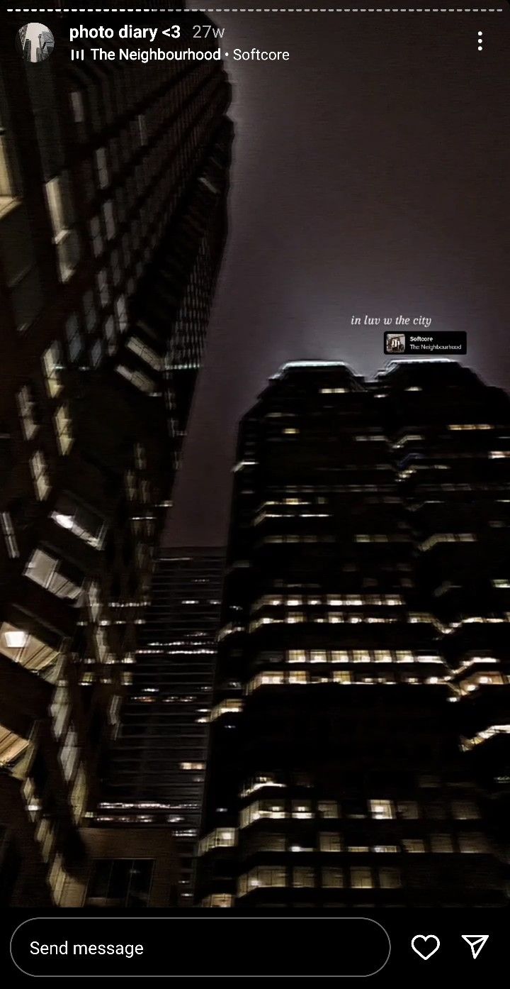 an image of a city at night taken from the ground looking up into the sky