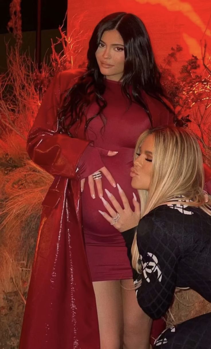 the pregnant woman is posing with her friend