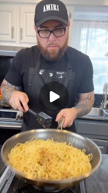 a man is cooking pasta in a pan on the stove