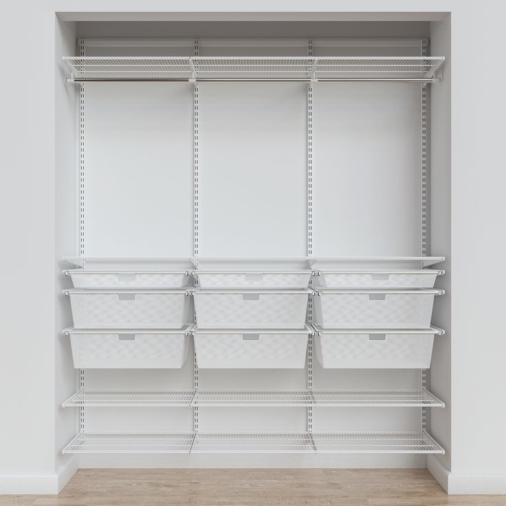 an empty closet with white shelves and baskets on the bottom shelf, in front of a wooden floor