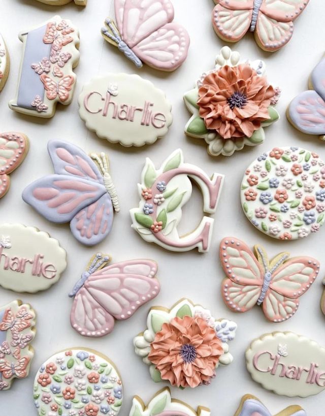 decorated cookies with butterflies and flowers on them for a baby's first birthday party