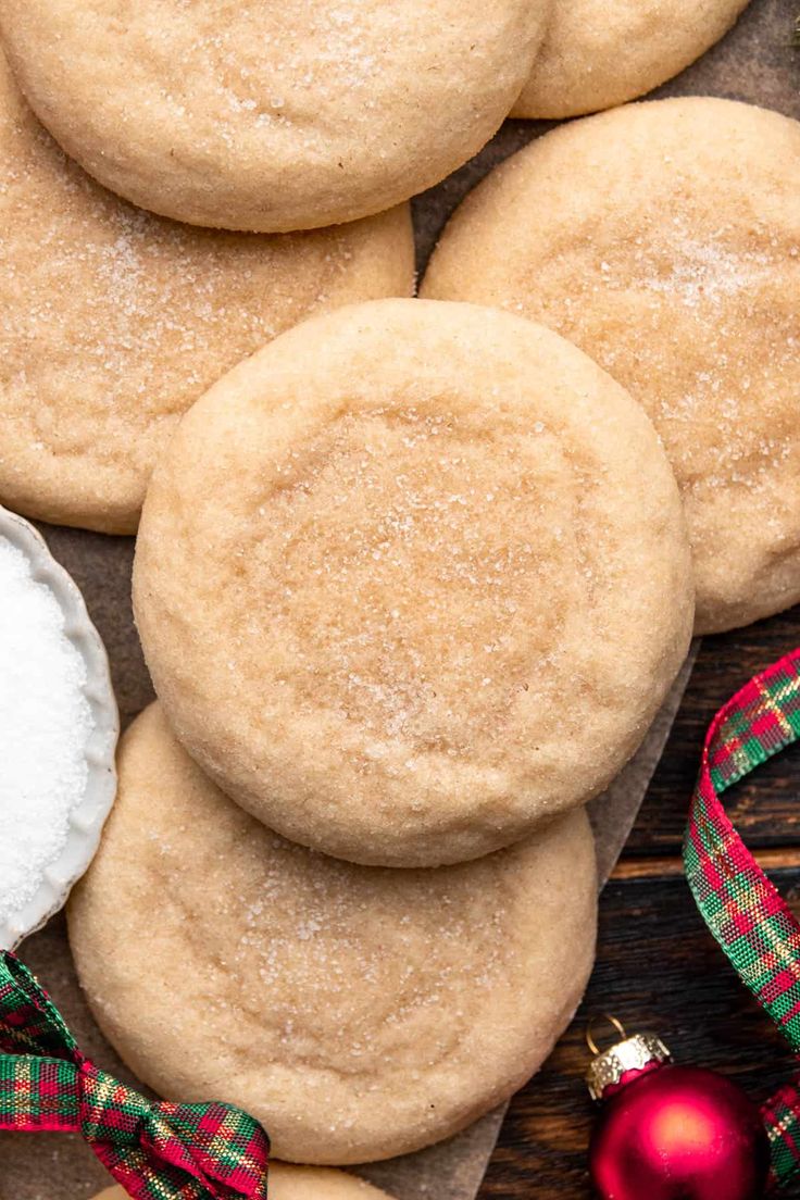 some sugar cookies are on a table next to christmas decorations